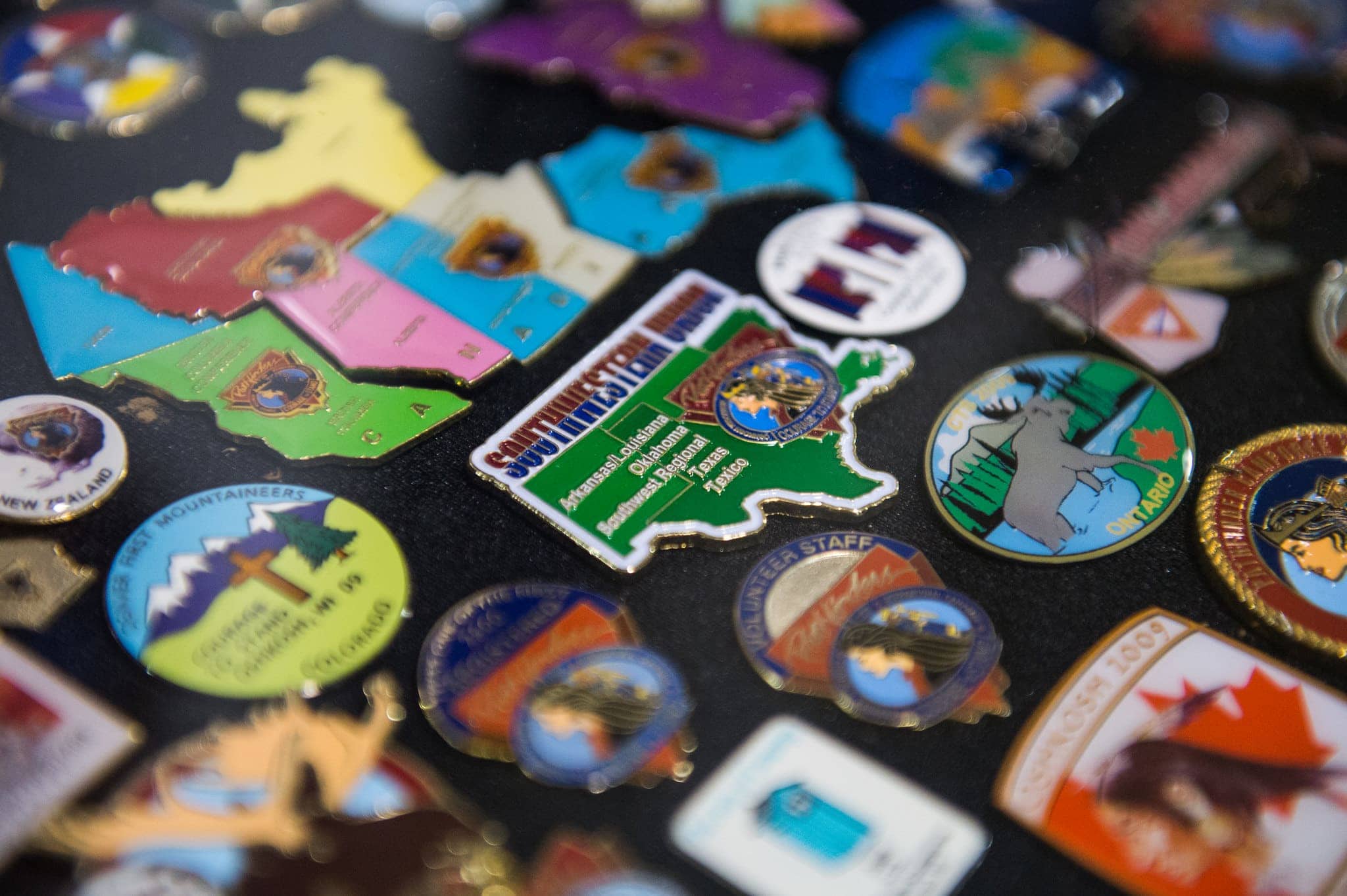 A Southwestern Union Conference Pathfinder pin stands out in the middle of a pin display board at the Pathfinder Heritage Museum at the 2014 “Forever Faithful” International Pathfinder Camporee in Oshkosh. [Photo: James Bokovoy Photography]