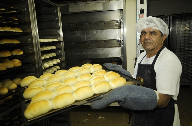 Thanks to Angels of Hope, Manoel got his life back and does what he knows best—he bakes almost 2,000 buns a night. [Photo by Kléber Lima]