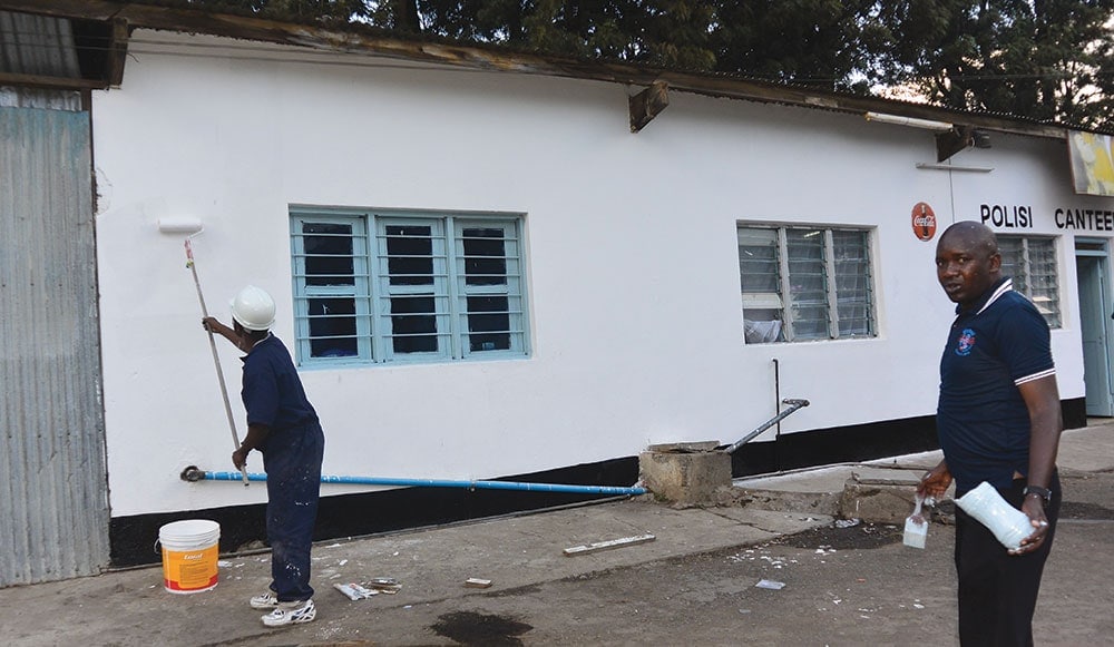 As part of their efforts to make their communities better places to live, local Adventists paint a police station in Tanzania. ECD Communications