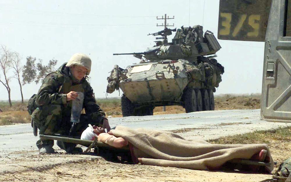 U.S. Navy Hospital Corpsman provides treatment to a wounded Iraqi soldier.
