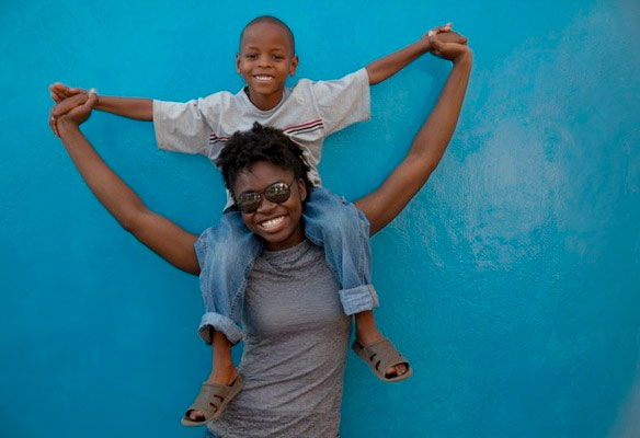 Sandra Owusu-Antwi, a student from Andrews University in the U.S., giving a ride to a child at an orphanage in Arusha, Tanzania, part of the East-Central Africa Division. “Remember, the Lord went up, the Holy Spirit came down, the church went out — and turned the world upside down!” Wilson said. “Shake Africa for Christ!” Photo: ANN
