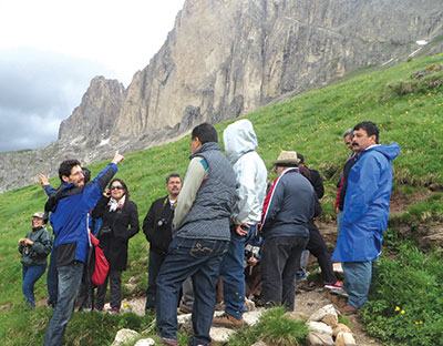 GRI staff member Ronny Nalin (left) explains the geology of the Dolomites during a field conference in Italy. 