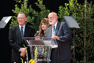 Dennis and Carol Troesh of Riverside, California, announce their $100 million gift for Loma Linda University Health’s Vision 2020 Campaign.  Richard H. Hart, president, is at right.