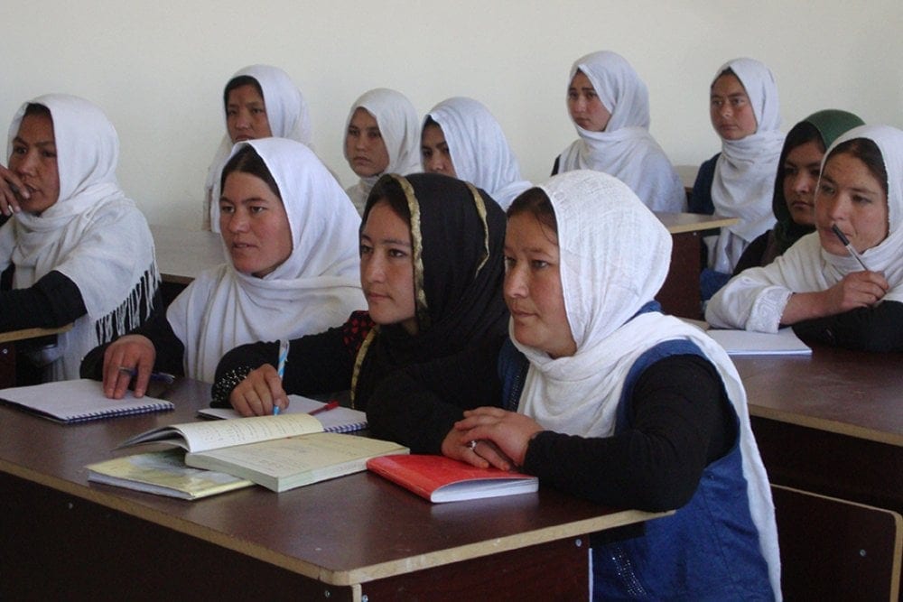 Education: Rokiza, right, and Ramila, center, studying at a school built by ADRA in Afghanistan. Rokiza’s father almost pulled her out of school because boys and girls studied in the same classrooms. Rokiza now goes to girls-only classes at the new school. 