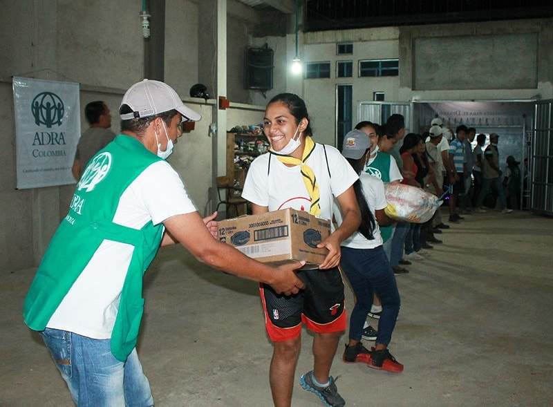 Church member volunteers work on gathering supplies for distribution hours after the disaster took place in Mocoa. [Photo by ADRA Colombia]