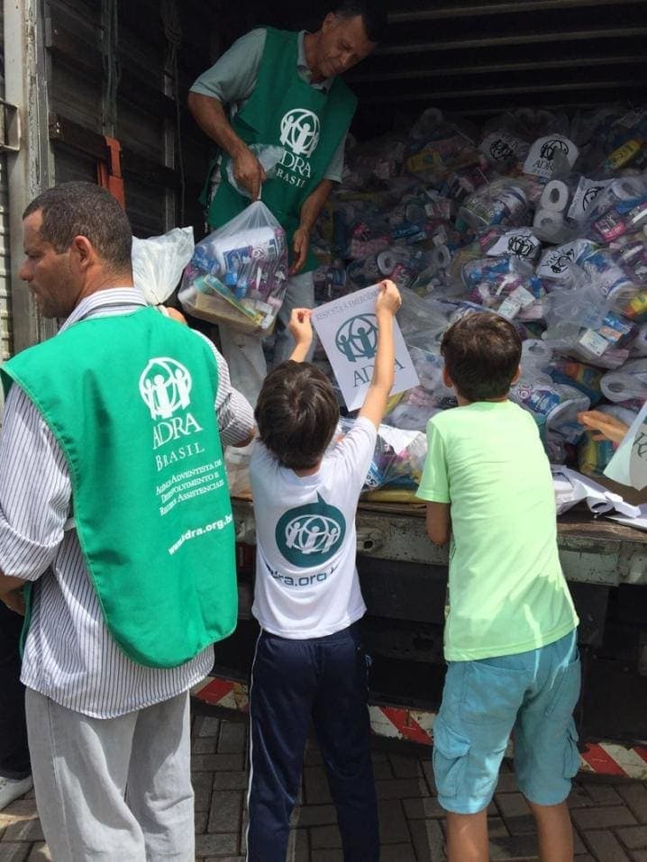 ADRA workers and schoolchildren loading hygiene kits on a truck in Brazil. (ADRA / ANN)