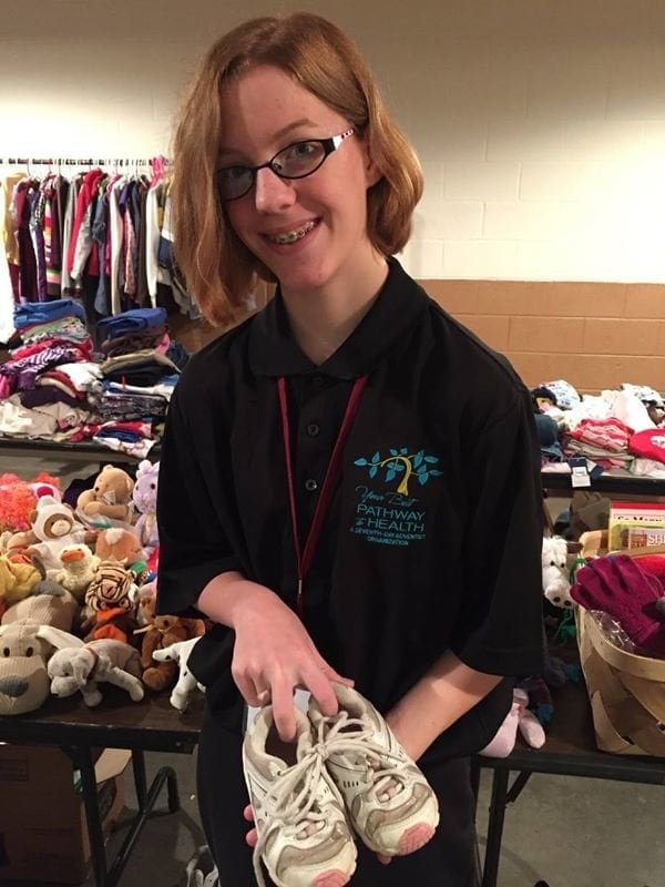 Olivia Lesko, 14, volunteers in the clothing distribution area. (Visitor)