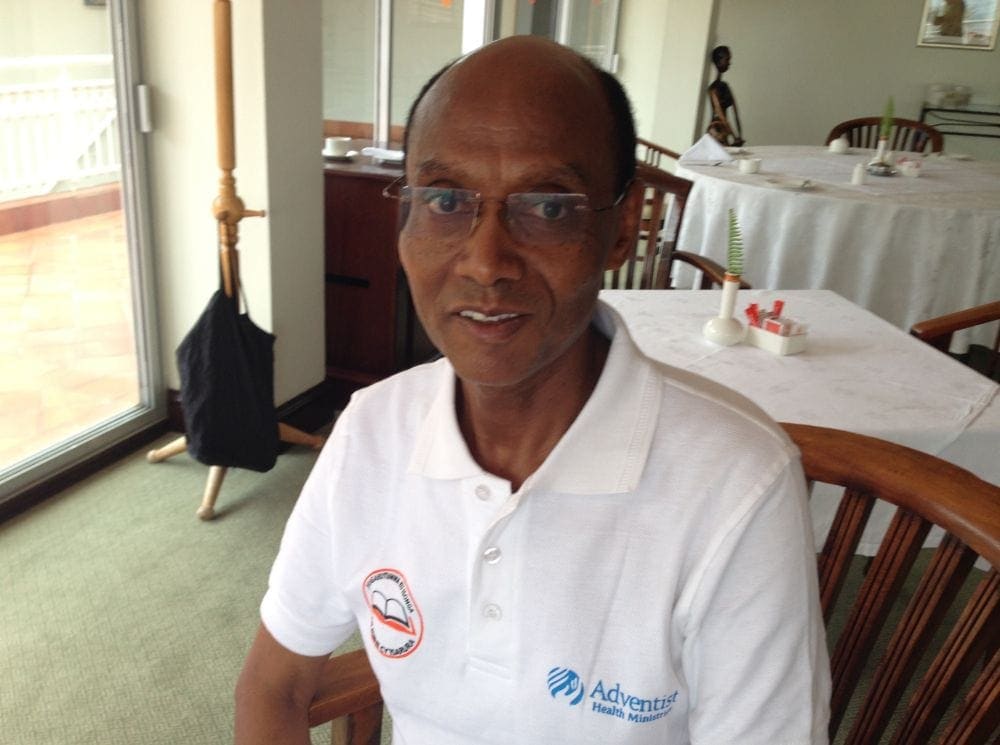 Dr. Fesaha Tsegaye speaking with the Adventist Review in the hotel dining hall where he met the chef.