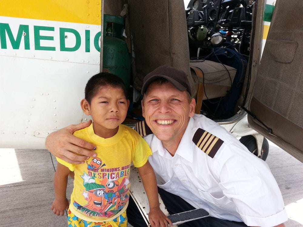 James Ash with one of the children assisted by his mission flights.