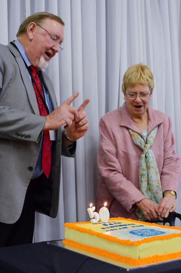 Asian Aid board chairman John Hammond thanking Helen Eager, a donor for 49 years, beside the anniversary cake.