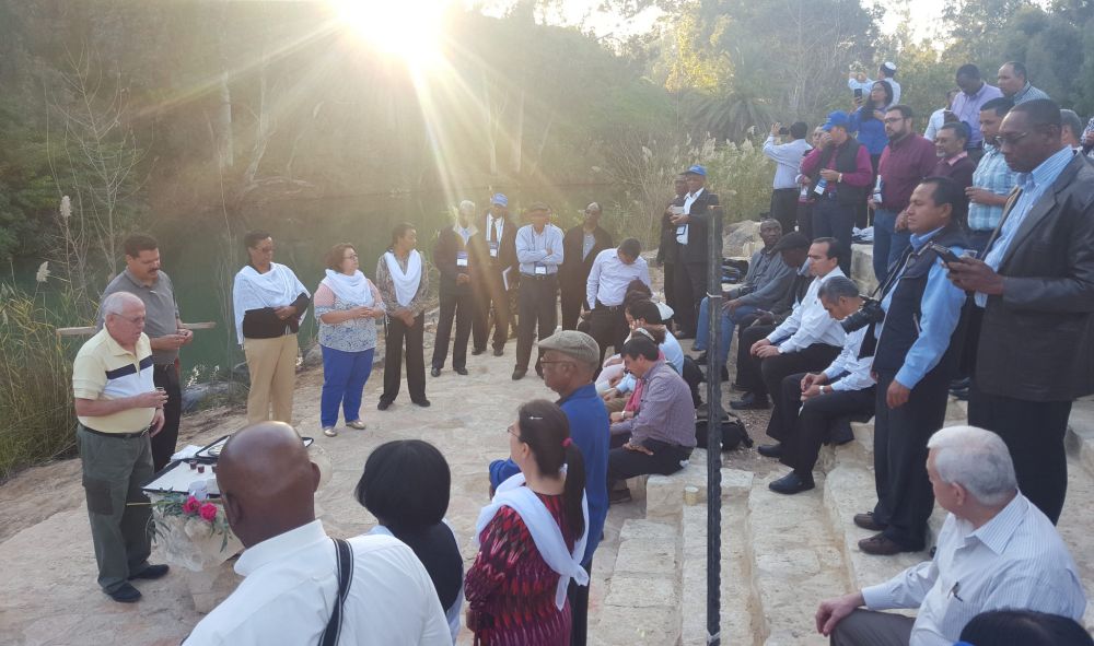 Church leaders partaking in a communion service near the Jordan River. (Gustavo Melendez / IAD)