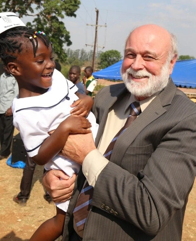 Richard Hart, president of Loma Linda University, enjoying a light moment with Tinashe Masina, a Malawian girl who dressed as a nurse for the anniversary celebration. “I am a nurse!” Tinashe exclaimed to Hart. “Who taught you?” he asked with a broad smile. “My sister did!” she replied. (All photos: Courtney Haas / Global Health Institute)