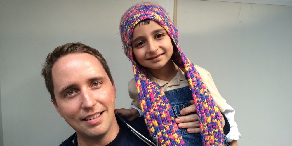 Dr. Michael-John Von Hörsten with a Syrian boy whom he treated on Lesbos. (Michael-John Von Hörsten)