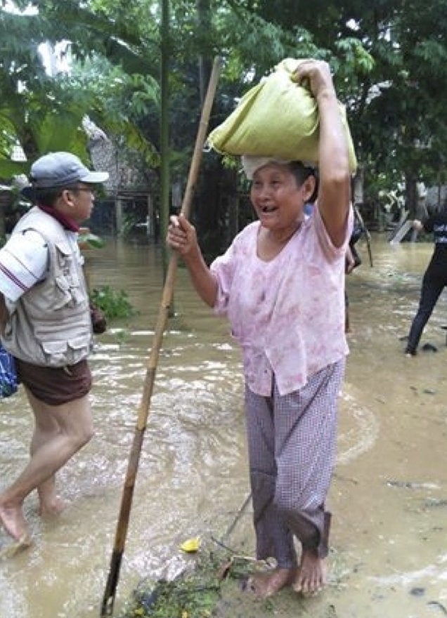 A grateful villager carrying away much-needed supplies from an Adventist relief team in Tone-Eain-Tan. (Myanmar Union Mission)