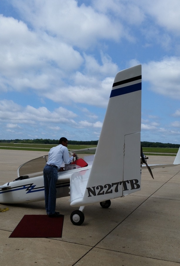 William Pergerson getting ready to leave his plane at the Battle Creek airport to ride into town with Bible worker Juanita Staten, who took this photo.