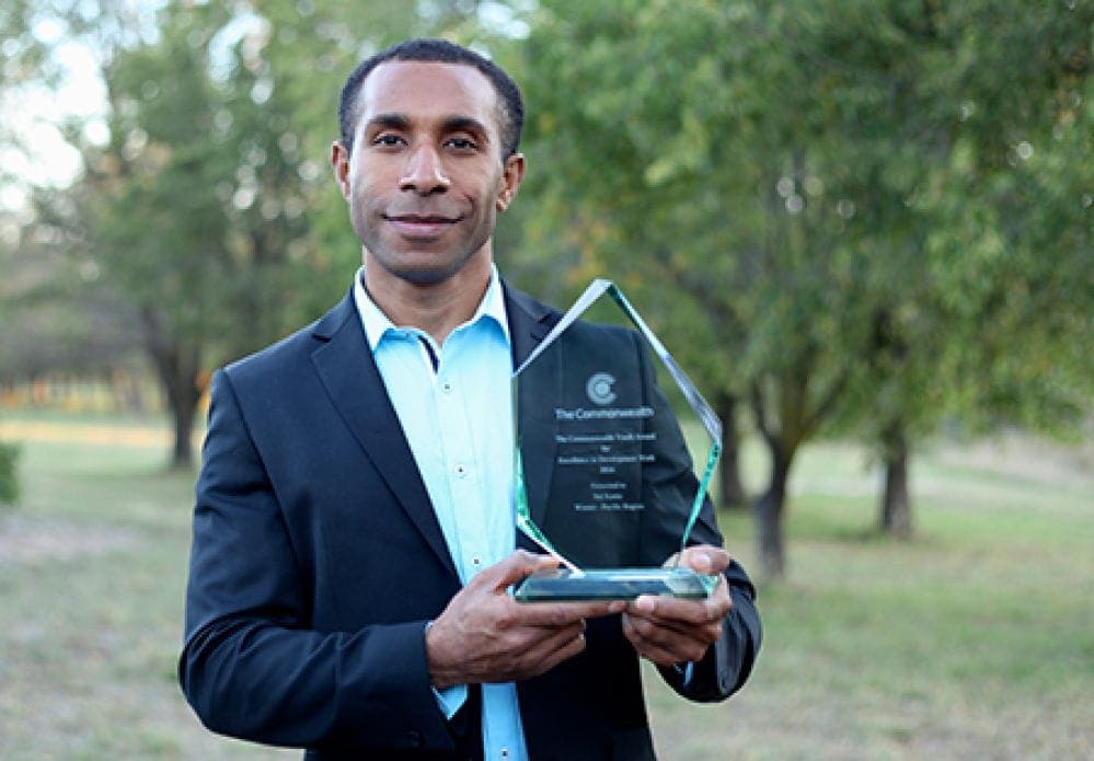 Bal Kama, a doctoral student in Australia, holding his award. (Sonja Larsen via Adventist Record)