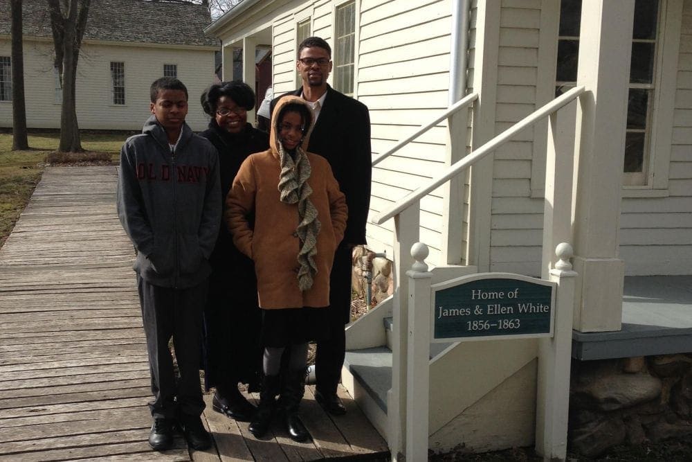 The Pergerson family visiting James and Ellen White's home in the Historic Adventist Village in Battle Creek, Michigan, on March 23, 2013. In the picture are William Carlson Pergerson II; his wife, Sharon; and their children, William III and Jaissa. (Fred Bischoff)