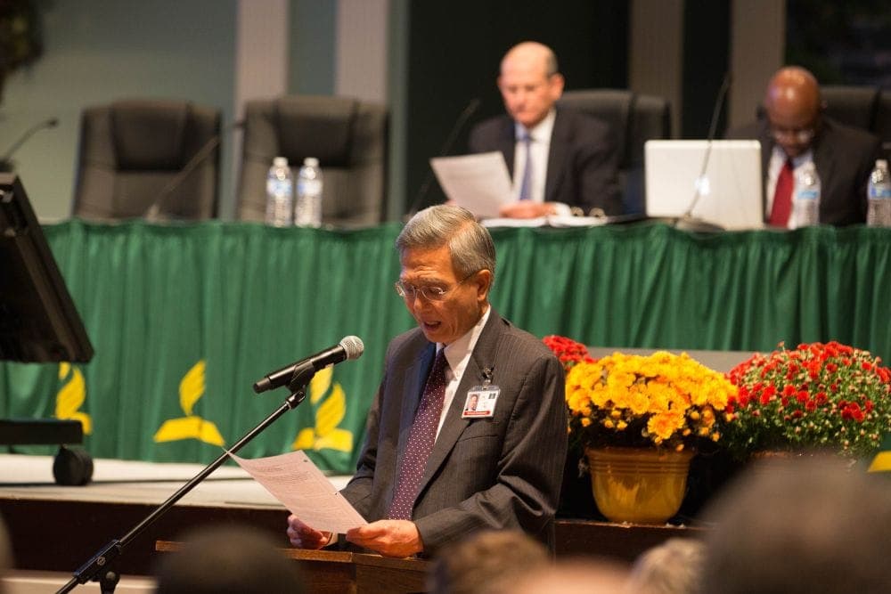 G.T. Ng reading the appeal to Annual Council attendees on Sunday. (Brent Hardinge / ANN)