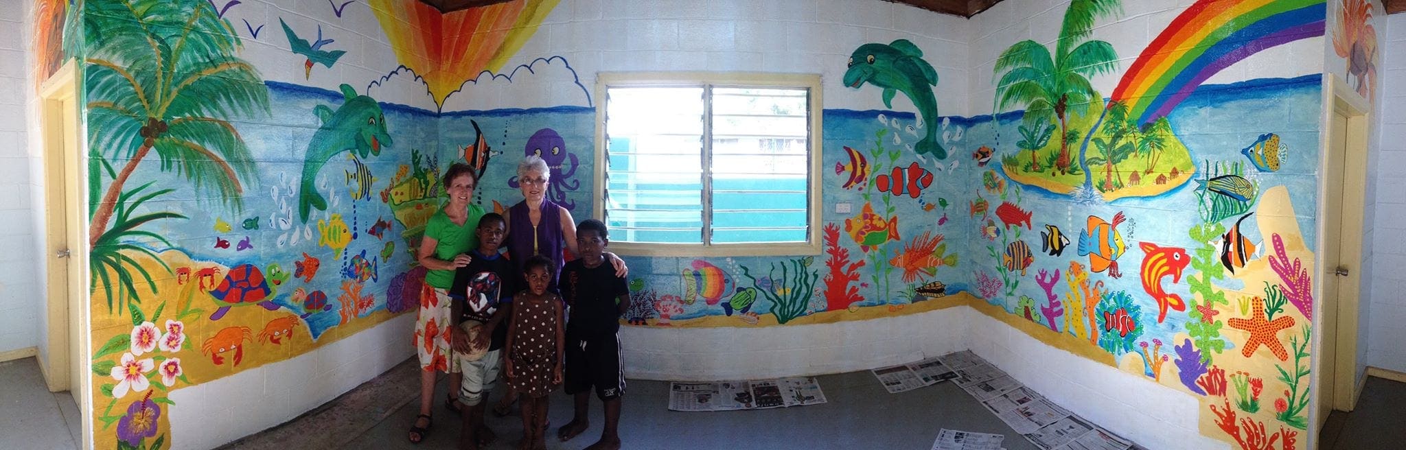 Iris Landa, left, standing in a repainted "Happy Room" with Joy Butler in Papua New Guinea. (Facebook)