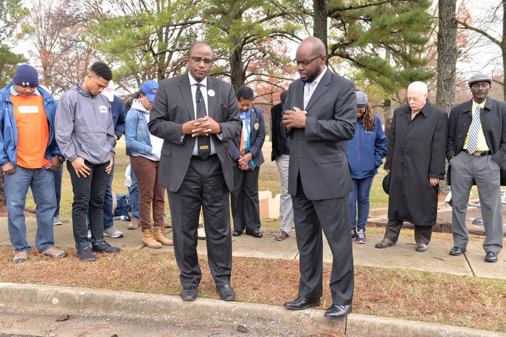 Leslie Pollard, left, praying at the dedication of new fitness stations around the university campus in late 2015. Oakwood received a $50,000 grant from Home Depot to build outdoor exercise circuits and a 2-mile (3-kilometer) walking trail. (Oakwood University)