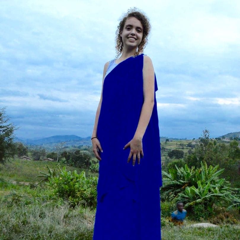Sophie Soler wearing the attire of Adventist deaconesses in Rwanda on a Rwandan hill. (Courtesy of author)
