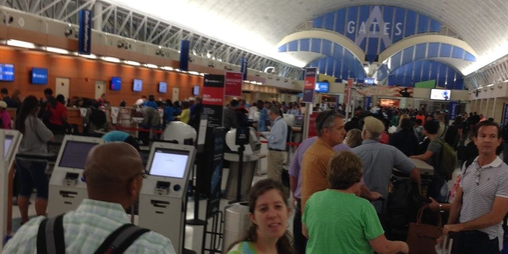 Delta passengers wait in a long line at the San Antonio airport at 4:40 a.m. Monday, July 13. (Andrew McChesney / AR)