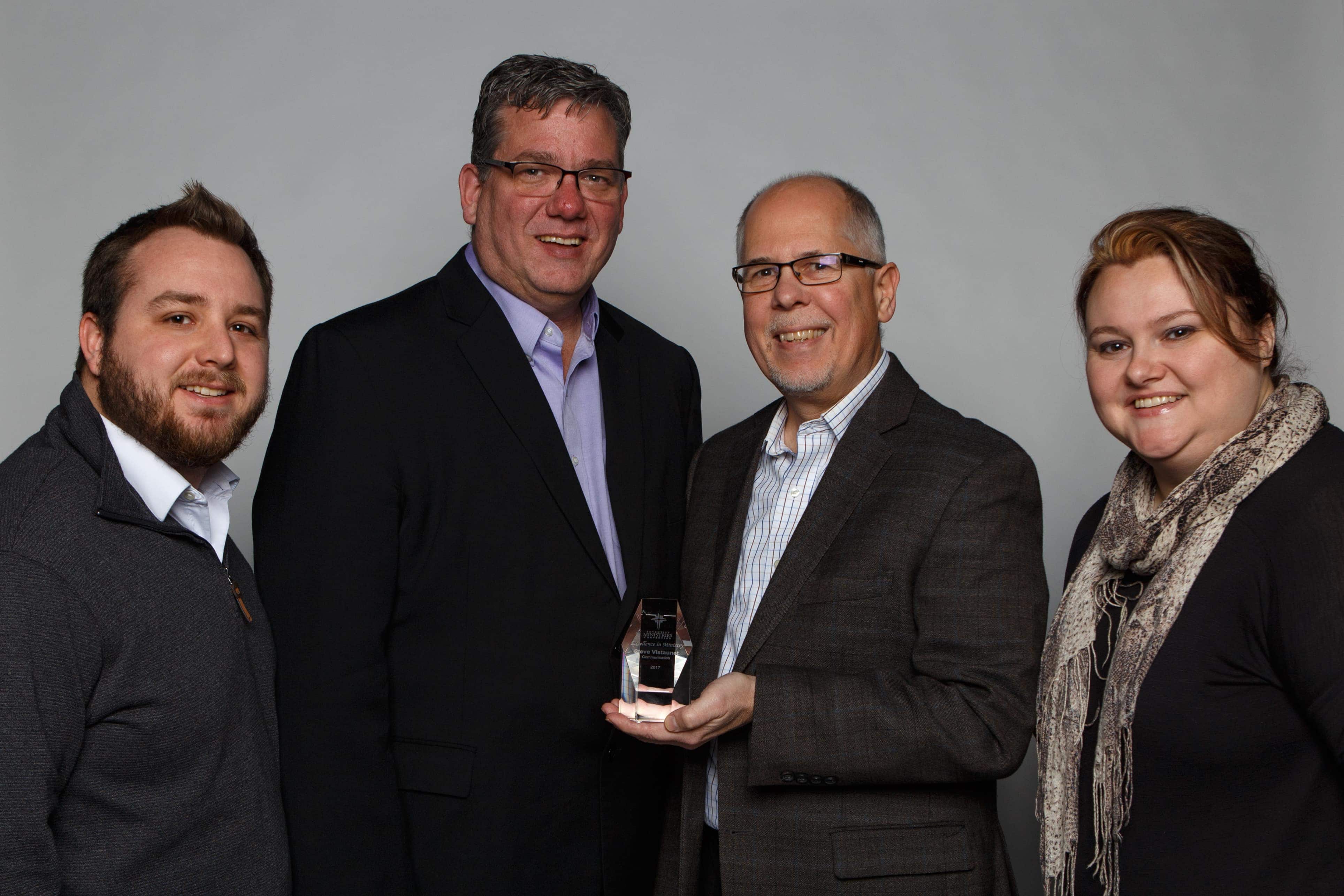 Left to right: Anthony White, Dan Weber, Steve Vistaunet, and Desiree Lockwood take a moment to celebrate the 2017 AMC Lifetime Achievement Award in Communication that Vistaunet was given at the ministries convention in January 2017. Photo provided by the North Pacific Union Gleaner.