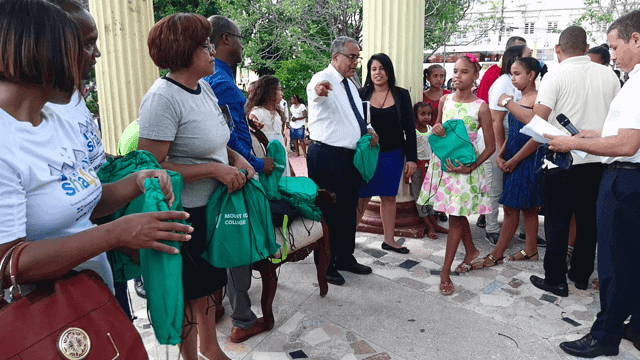 Pastor Cesario Acevedo, president of the church in the Dominican Republic, distributes backpacks with church leaders during the citywide visit in Juan Pablo Duarte in Azua in southern Dominican Republic. Image by ADRA Dominican Republic.