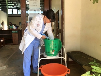Dr. Gillian Seton washes her hands at one of the hand-washing stations at Malamulo Hospital. 
