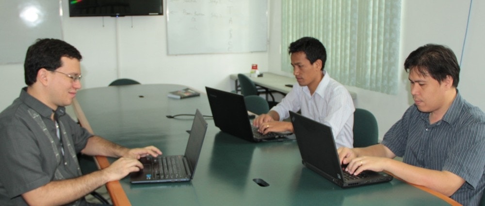 From left, Raimond Luntungan, Thang Do Lian, and Pablo Rios meeting with Richli, unpictured, on the AIIAS campus. Photo: Claude Richli