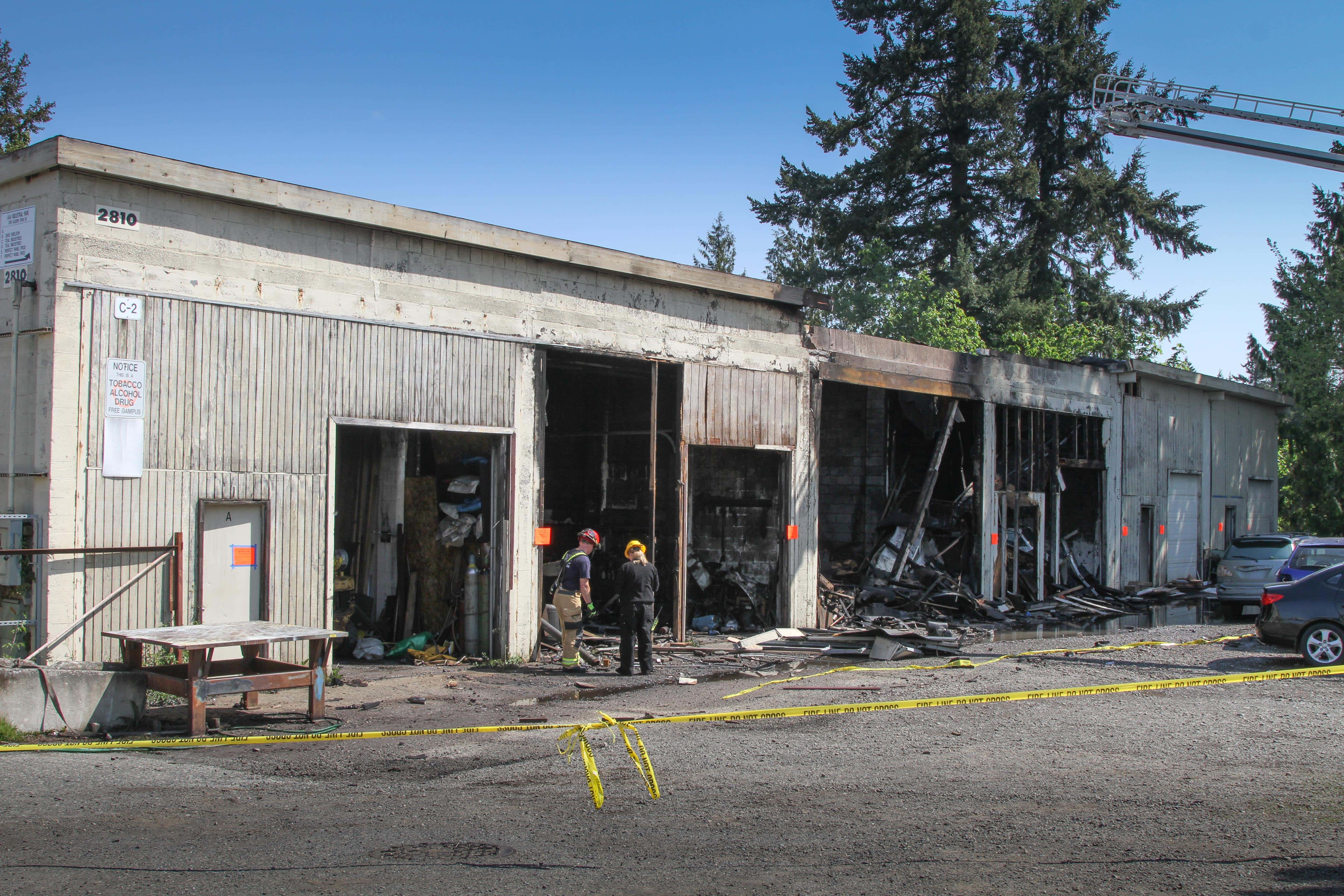 Firefighters inspecting the charred shell of the warehouse on Friday, May 8. (Heidi Baumgartner)