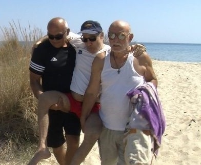 John’s father and a friend from church help carry him after his baptism in the Aegean Sea. Members said they were delighted to have witnessed the ceremony. [Photo: Trans-European Division News]