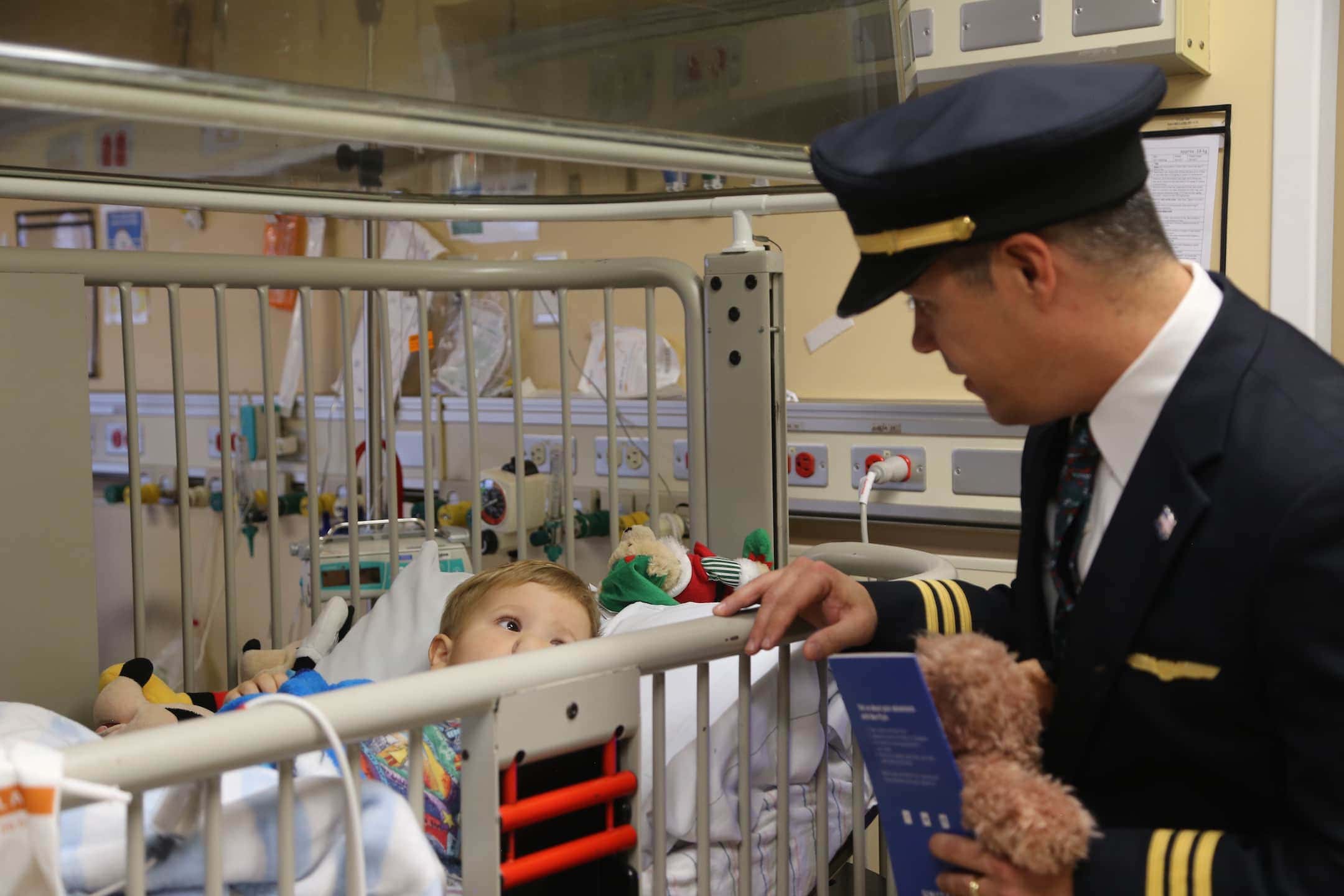 United Airlines pilot Fabio Silveira visited with LLUCH patient Ryan Byrne, 2, of Apple Valley on Thursday, Dec. 22