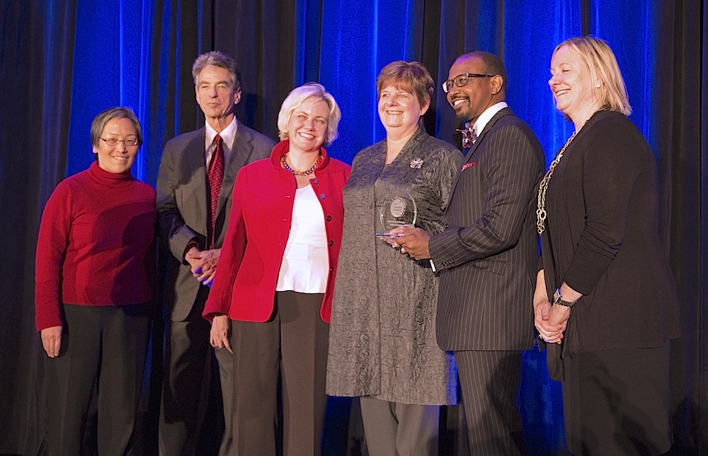 Loma Linda administrators Marie Hodgkins and Lyndon Edwards hold the Top Teaching Hospital Award after receiving it Dec. 6 in Washington, DC. They are pictured with individuals including Leapfrog’s Leah Binder (center, in red) & Laurel Pickering (right).  Credit: LLU