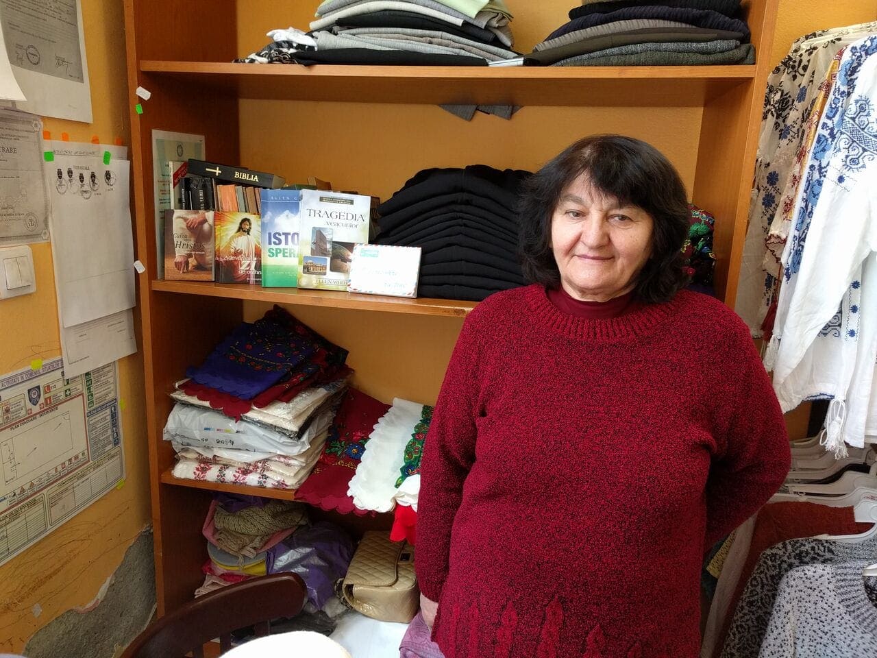 Marioara Tulcan stands in her clothing store which combines regular business with discussions on religious topics and sharing Seventh-day Adventist literature in Arad, Romania. [Photo by Ciprian Savischi] 