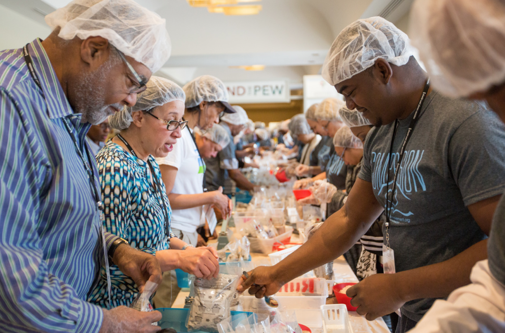 Seventh-day Adventists attending the 2017 North American Division Adventist Ministries Convention in Tucson, Arizona, pack bagged meals for a Stop Hunger Now project. (Photo by Pieter Damsteegt/NAD)