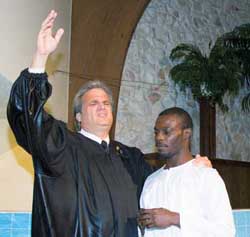 Pastor Frank Gonzalez baptizes John Taylor 