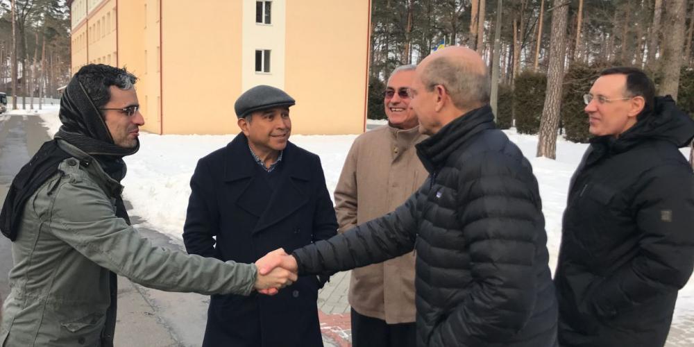 General Conference president Ted Wilson, second right, greeting lay evangelists from Mexico on an Adventist college campus in Bucha, Ukraine, on Feb. 2, 2017, as Euro-Asia Division president Michael Kaminskiy, right, watches. (Andrew McChesney / Adventist Mission)