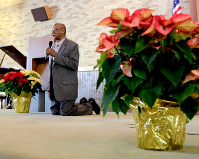 <strong>CONGREGATIONAL PRAYER:</strong> Head Elder Lester McLean leads the congregation in prayer at the Wyoming Valley Seventh-Day Adventist Church in Hudson on Saturday morning. [Bill Tarutis/Times Leader]