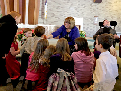 <strong>STORY TIME:</strong> Karen Castillo lets children smell honey during a children's story at the Wyoming Valley Seventh-Day Adventist Church in Hudson. [Bill Tarutis/Times Leader]