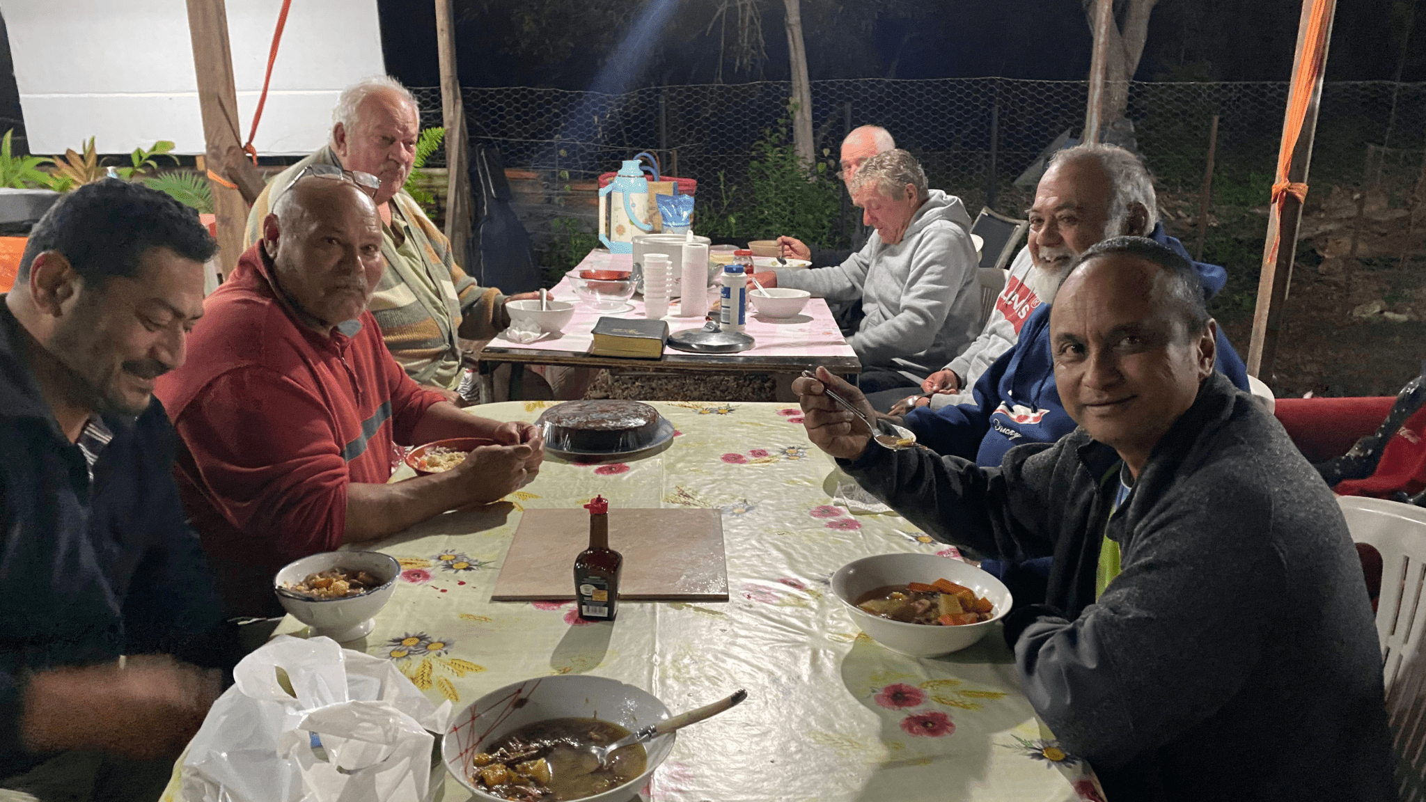 Some of the small-group members enjoying a meal together in Tomo village, New Caledonia. [Photo: Adventist Record]