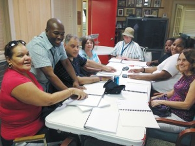 Dexter Thomas, second from left, has a doctor of ministry degree and teaches a braille class at West Palm Beach Braille Readers’ Club. “Visually impaired individuals are accustomed to people rushing by and feeling lonely in a sighted world,” he said. “When we reached out to them, we were able to bring confidence and assurance that there are still people in the world who care.” (Photo: William Verdekal)