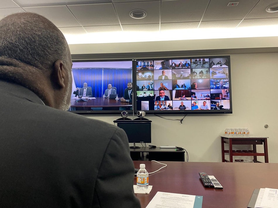 Inter-American Division president Elie Henry (left) is joined by fellow administrators in Miami, during videoconference meetings with the 24 union administrators. [Photo: Abel Márquez, Inter-American Division News]