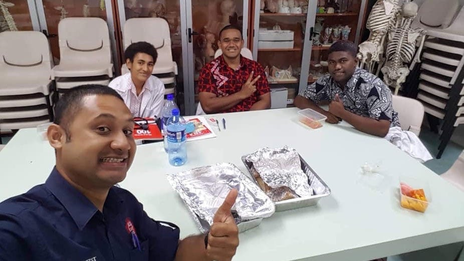 Medical students Etuate Logaivau, Matelita Waqatabu, and Brandon Talota, with Doctor Alipate Vakamocea (center), before commencing their final exam. Fiji National University approved the three Adventist final-year medicine students the right to sit their final exam after sunset on Saturday, November 23, 2019. [Photo: courtesy of Adventist Record]