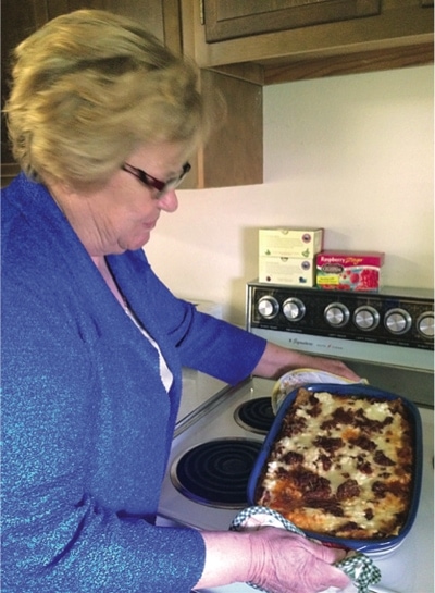 South Dakota church member Lois Roggow with a pan of homemade lasagna. Photo: Outlook