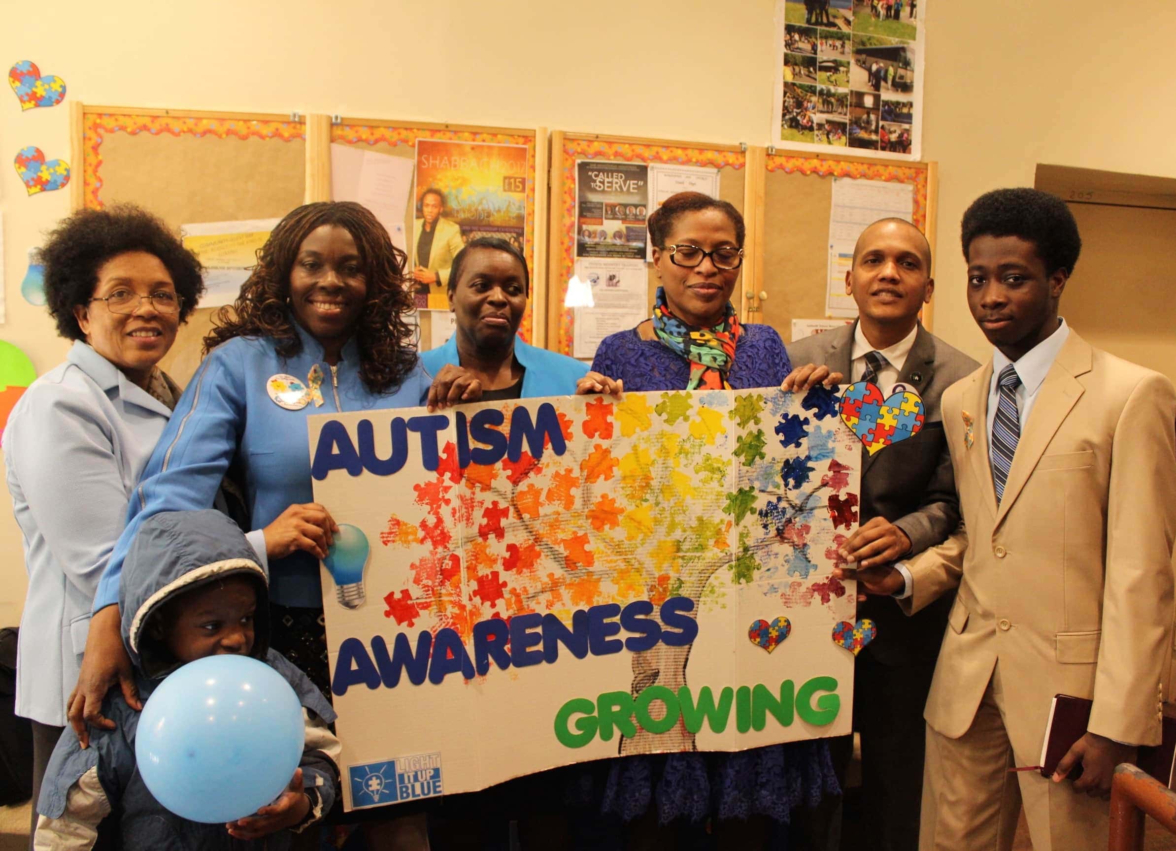 From left, standing and holding a sign about autism awareness are Cheryl Silvera, Greater New York Conference Disabilities Ministries coordinator; Everette B. Samuel, Maranatha church associate pastor; Jennifer Craig-Clarke, Maranatha church member; Udene Slater, Berean church member; Manuel Rosario, Greater New York Conference Sabbath School and Personal Ministries director; and Ayinde Nelson, Maranatha church member. [Photo: Atlantic Union Gleaner]