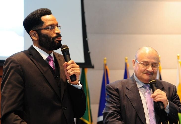 Ron C. Smith, left, president of the Southern Union Conference, speaking to division leaders as Jaime Castrejon, president of the Inter-American Adventist Theological Seminary, interprets. (Libna Stevens / IAD)