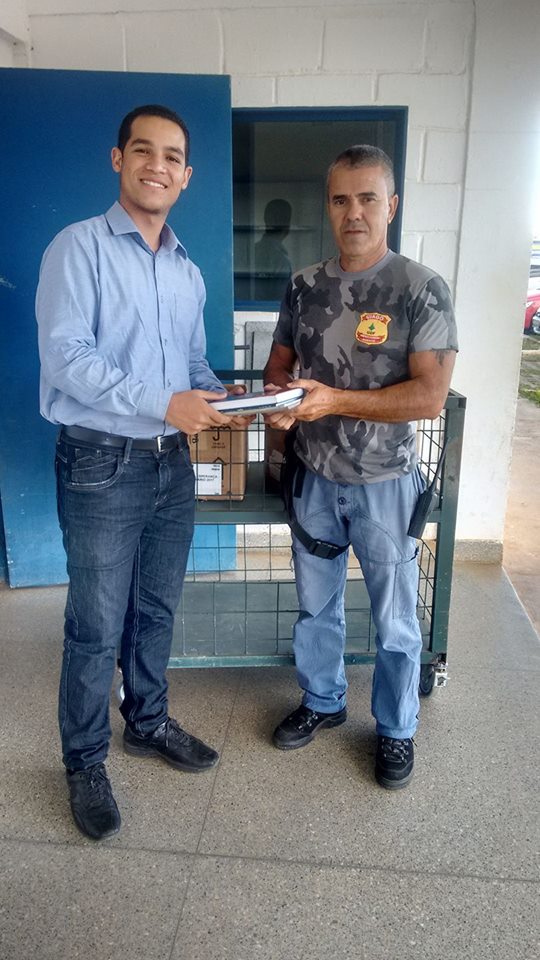 Jeconias Neto delivering Christian literature at a prison in Brazil's capital city area. Neto has been recently selected as a UN Youth Ambassador. [South American Division News]