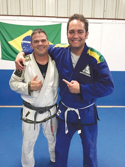 Cleber Machado, right, pastor of the Orlando Central Church, trains in Brazilian Jiujitsu with his instructor, Leo Gocking. (Florida Conference)