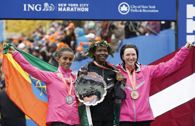 Priscah Jeptoo (center) a Seventh-day Adventist from Kenya, poses with fellow competitors after winning the women’s title at the New York City Marathon on November 3. Jeptoo is a member of the Adventist Athletic Association in Kenya.